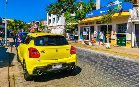 Puerto Escondido Oaxaca Mexico March 24, 2023 Typical beautiful colorful tourist street road and sidewalk with city life cars traffic buildings hotels bars restaurants and people in Zicatela Mexico.のeditorial素材