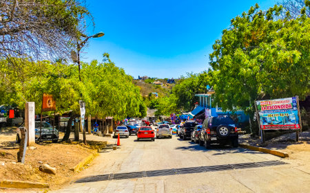 Puerto Escondido Oaxaca Mexico March 25, 2023 Typical beautiful colorful tourist street road and sidewalk with city life cars traffic buildings hotels bars restaurants and people in Zicatela Mexico.のeditorial素材
