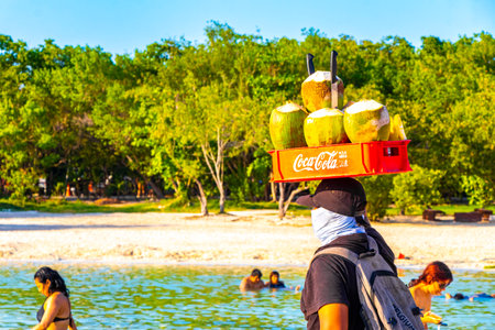 Playa del Carmen Quintana Roo Mexico May 03, 2023 Beach vendor with coco coconut coconuts food basket box on head in Playa del Carmen Quintana Roo Mexico.のeditorial素材