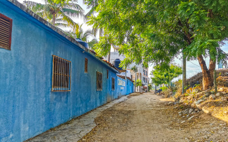 Puerto Escondido Oaxaca Mexico October 17, 2022 Typical beautiful colorful tourist street road and sidewalk with city life cars traffic buildings hotels bars restaurants and people in Zicatela Mexico.のeditorial素材