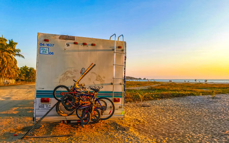 Puerto Escondido Oaxaca Mexico January 8, 2023 Various minibuses vans transporters vehicles cars camper bus car at sunset in Puerto Escondido Zicatela Oaxaca Mexico.のeditorial素材