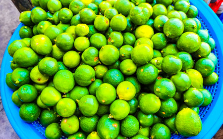 Green juicy lime lemon citrus fruit fruits background texture from market supermarket in Puerto Escondido Oaxaca Mexico.の写真素材