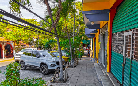 Puerto Escondido Oaxaca Mexico January 20, 2023 Typical beautiful colorful tourist street road and sidewalk with city life cars traffic buildings hotels bars restaurants and people in Zicatela Mexico.のeditorial素材
