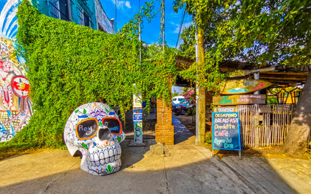 Puerto Escondido Oaxaca Mexico January 20, 2023 Typical beautiful colorful tourist street road and sidewalk with city life cars traffic buildings hotels bars restaurants and people in Zicatela Mexico.のeditorial素材