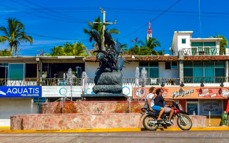 Puerto Escondido Oaxaca Mexico January 20, 2023 Typical beautiful colorful tourist street road and sidewalk with city life cars traffic buildings hotels bars restaurants and people in Zicatela Mexico.のeditorial素材