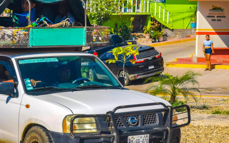 Puerto Escondido Oaxaca Mexico January 20, 2023 Typical beautiful colorful tourist street road and sidewalk with city life cars traffic buildings hotels bars restaurants and people in Zicatela Mexico.のeditorial素材