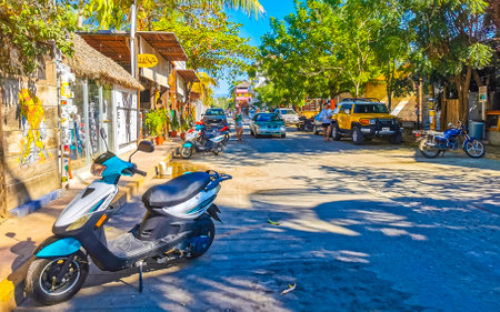 Puerto Escondido Oaxaca Mexico January 27, 2023 Typical beautiful colorful tourist street road and sidewalk with city life cars traffic buildings hotels bars restaurants and people in Zicatela Mexico.のeditorial素材