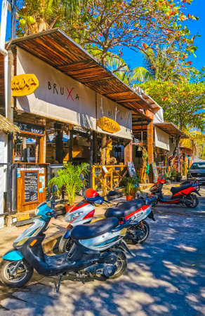 Puerto Escondido Oaxaca Mexico January 27, 2023 Typical beautiful colorful tourist street road and sidewalk with city life cars traffic buildings hotels bars restaurants and people in Zicatela Mexico.のeditorial素材