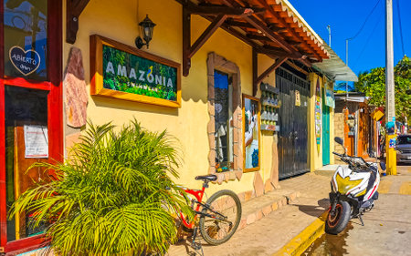 Puerto Escondido Oaxaca Mexico January 27, 2023 Typical beautiful colorful tourist street road and sidewalk with city life cars traffic buildings hotels bars restaurants and people in Zicatela Mexico.のeditorial素材