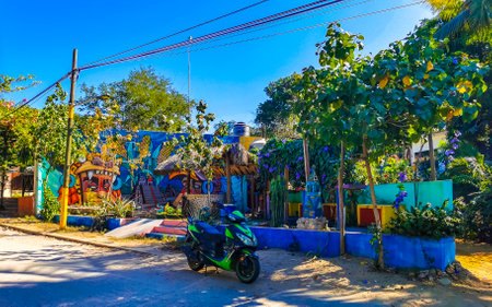 Puerto Escondido Oaxaca Mexico January 27, 2023 Typical beautiful colorful tourist street road and sidewalk with city life cars traffic buildings hotels bars restaurants and people in Zicatela Mexico.のeditorial素材