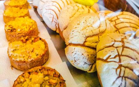 Bread rolls baguettes cakes and other pastries in shop window showcase in Zicatela Puerto Escondido Oaxaca Mexico.の写真素材