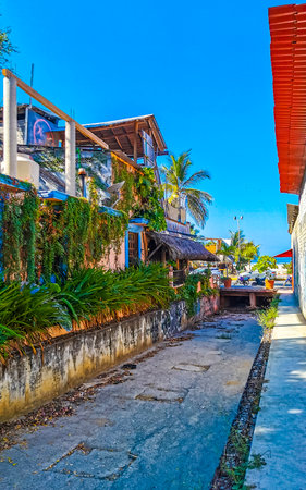 Puerto Escondido Oaxaca Mexico February 15, 2023 Typical beautiful colorful tourist street road and sidewalk with city life cars traffic buildings hotels bars restaurants and people in Zicatela Mexico.のeditorial素材