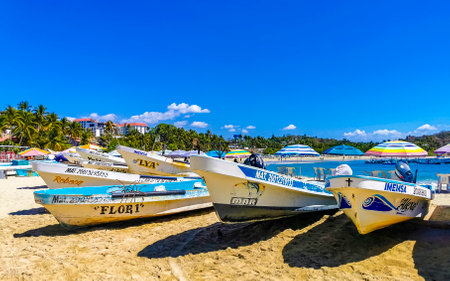 Puerto Escondido Oaxaca Mexico February 15, 2023 Fishing boats at the harbor and beach by Zicatela in Puerto Escondido Oaxaca Mexico.のeditorial素材