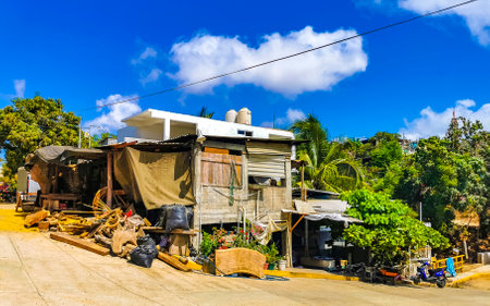 Puerto Escondido Oaxaca Mexico March 24, 2023 Typical beautiful colorful tourist street road and sidewalk with city life cars traffic buildings hotels bars restaurants and people in Zicatela Mexico.のeditorial素材