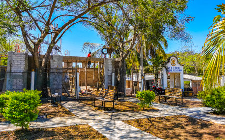 Puerto Escondido Oaxaca Mexico March 25, 2023 Typical beautiful colorful tourist street road and sidewalk with city life cars traffic buildings hotels bars restaurants and people in Zicatela Mexico.のeditorial素材