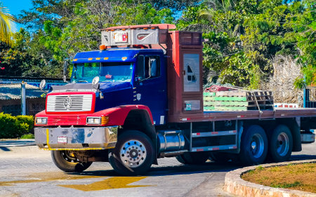Puerto Escondido Oaxaca Mexico March 28, 2023 Blue and red old Mexican truck transporter delivery car in Zicatela Puerto Escondido Oaxaca Mexico.のeditorial素材
