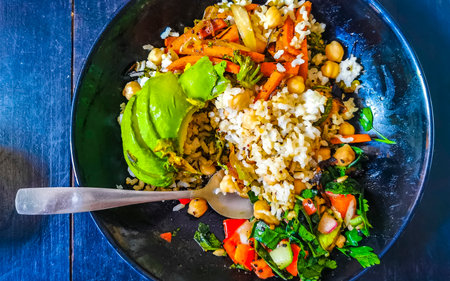 Plate with vegan dish of chickpeas rice vegetables chia seeds and salad in Playa del Carmen Quintana Roo Mexico.の写真素材