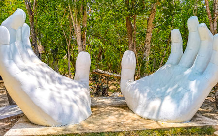 White hands sculpture figure statue building in tropical jungle near cenote Yaxmuul in Tulum Quintana Roo Mexico.のeditorial素材