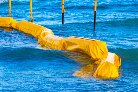 Beautiful blue and turquoise water waves ocean and yellow red orange Buoy buoys ropes and nets in...