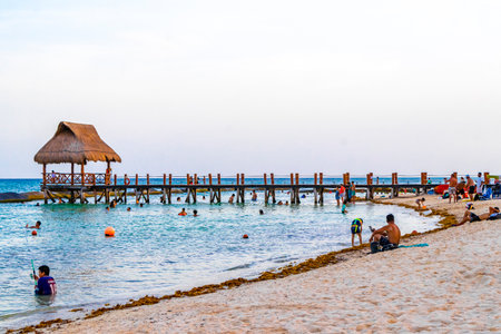 Playa del Carmen Quintana Roo Mexico August 14, 2023 Tropical mexican caribbean beach landscape panorama with clear turquoise blue water and jetty pier with palapa bungalow in Punta and Playa Xcalacoco Playa del Carmen Mexico.のeditorial素材