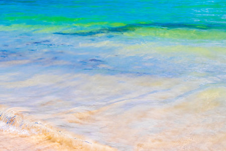 Waves water and sand at tropical Mexican beach landscape panorama and Caribbean sea with clear turquoise blue water in Playa del Carmen Mexico.の写真素材