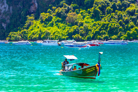 Koh Phi Phi Krabi Thailand October 21, 2018 Longtail boat boats at the beautiful famous beach lagoon between limestone rocks and turquoise water on Koh Phi Phi Don island in Ao Nang Krabi Thailand.のeditorial素材