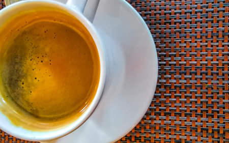 Glass cup of americano black coffee with spoon and plate on table food and drink in the restaurant cafe in Playa del Carmen Quintana Roo Mexico.の写真素材