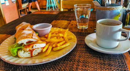 Baguette or sandwich toast bread with chicken tomato salad and potato fries in Playa del Carmen Quintana Roo Mexico.の写真素材