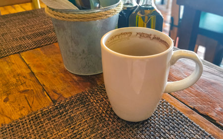 Glass cup of americano black coffee with spoon and plate on table food and drink in the restaurant cafe in Playa del Carmen Quintana Roo Mexico.の写真素材