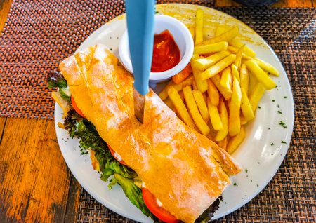 Baguette or sandwich toast bread with chicken tomato salad and potato fries in Playa del Carmen Quintana Roo Mexico.の写真素材