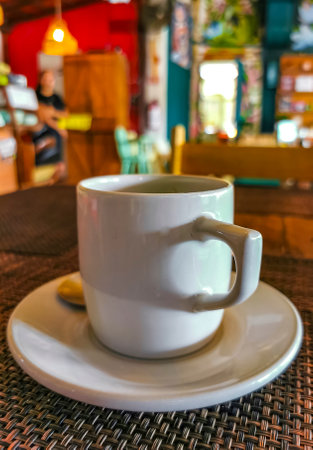 Glass cup of americano black coffee with spoon and plate on table food and drink in the restaurant cafe in Playa del Carmen Quintana Roo Mexico.の写真素材