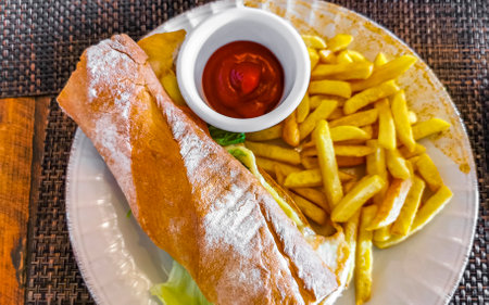 Baguette or sandwich toast bread with chicken tomato salad and potato fries in Playa del Carmen Quintana Roo Mexico.の写真素材