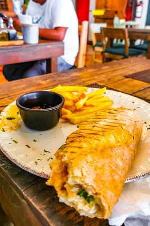 Baguette or sandwich toast bread with chicken tomato salad and potato fries in Playa del Carmen Quintana Roo Mexico.の写真素材