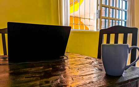Playa del Carmen Quintana Roo Mexico April 11, 2021 Laptop work at table with coffee cup at home office and cafe in Playa del Carmen Quintana Roo Mexico.の写真素材