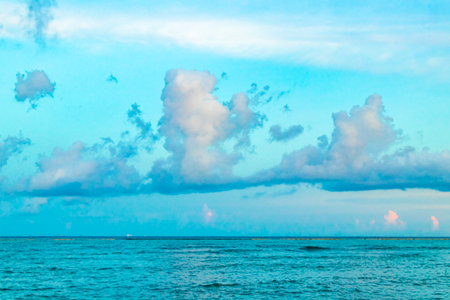 Awesome amazing and colorful sunset sunrise at the tropical Mexican Caribbean beach landscape panorama with clear turquoise blue water resorts and palm trees in Playa del Carmen Mexico.の写真素材
