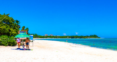 Playa del Carmen Quintana Roo Mexico September 9, 2023 Tropical Mexican Caribbean beach and sea with a lot of fun people sun loungers parasols turquoise water in Playa del Carmen Mexico.のeditorial素材