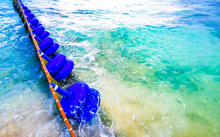 Tropical Mexican Caribbean beach and sea with Sargazo seaweed sea weed net rope and buoys in clear turquoise blue water in Playa del Carmen Mexico.の写真素材