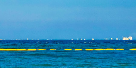 Tropical Mexican Caribbean sea and beach landscape panorama view to Cozumel island cityscape with clear turquoise blue water in Playa del Carmen Quintana Roo Mexico.の写真素材