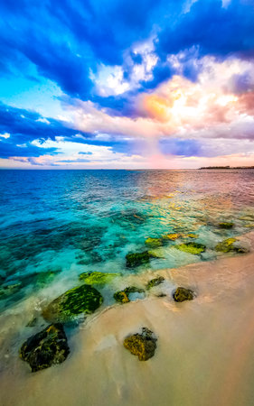 Awesome amazing and colorful sunset sunrise at the tropical Mexican Caribbean beach landscape panorama with clear turquoise blue water resorts and palm trees in Playa del Carmen Mexico.の写真素材