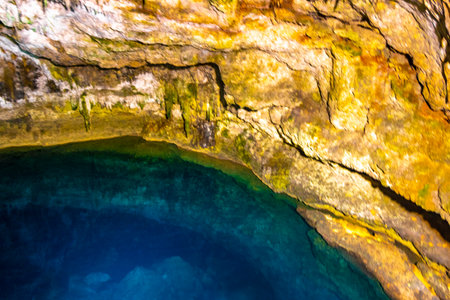 Cenote Tankach Ha Tankach-Ha sinkhole with limestone rocks and blue turquoise water in Coba Municipality Tulum Quintana Roo Mexico.の写真素材
