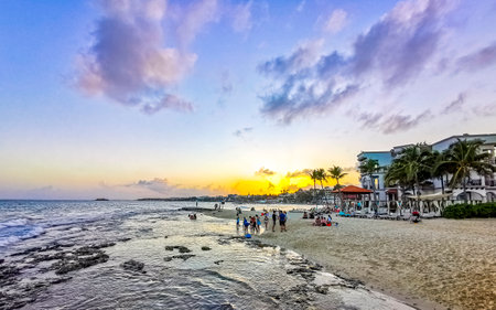 Playa del Carmen Quintana Roo Mexico February 18, 2022 Colorful and golden sunset and sunrise in the tropical Caribbean with palm trees and clouds in Playa del Carmen Quintana Roo Mexico.のeditorial素材