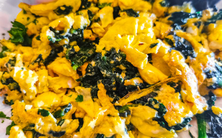 Mexican breakfast with scrambled eggs with spinach fruit and potatoes nicely arranged on white plate in Playa del Carmen Quintana Roo Mexico.の写真素材