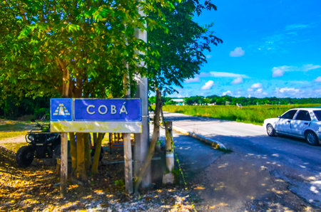 Coba Maya Ruins the ancient buildings and pyramids entrance welcome sign in the tropical forest jungle in Coba Municipality Tulum Quintana Roo Mexico.の写真素材