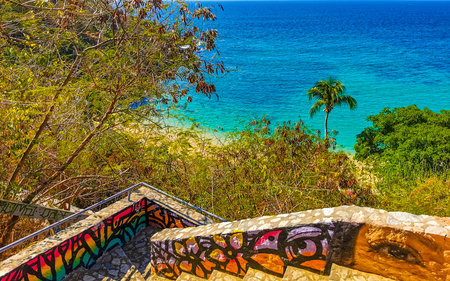 Puerto Escondido Oaxaca Mexico February 01, 2023 Stone stairs steps trail with paintings art down to...