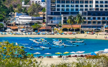 Puerto Escondido Oaxaca Mexico February 15, 2023 Fishing boats at the harbor and beach by Zicatela in Puerto Escondido Oaxaca Mexico.のeditorial素材
