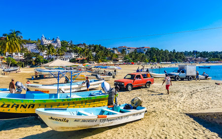 Puerto Escondido Oaxaca Mexico February 15, 2023 Fishing boats at the harbor and beach by Zicatela in Puerto Escondido Oaxaca Mexico.のeditorial素材