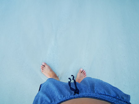 Feet of a man on beach sand and sea water in Playa del Carmen Quintana Roo Mexico.の写真素材