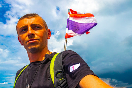 Man male handsome tourist on a ferry to Ao Nang in Ratsada Amphoe Mueang Phuket on Phuket island Thailand in Southeastasia Asia.の写真素材