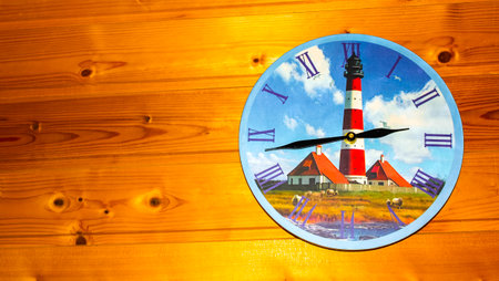 Clock on wooden wall in wooden hut with lighthouse and Friesland picture in Hemmoor Hechthausen...