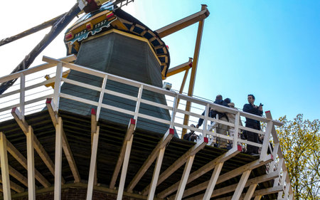 Lisse South Holland Netherlands April 4, 2014 Old beautiful wooden mill with people tourists in Keukenhof Lisse South Holland Netherlands Holland in Europe.のeditorial素材